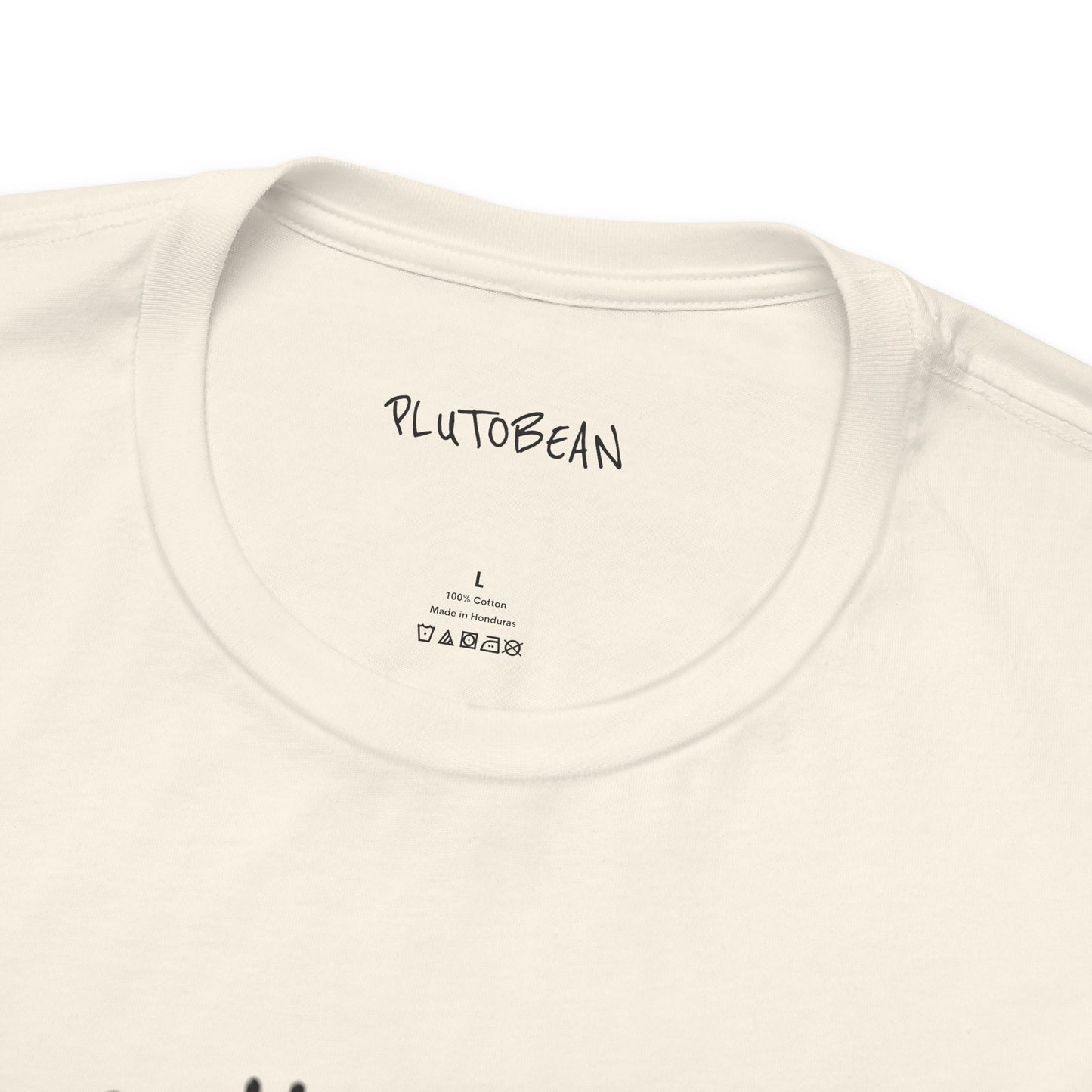 Close-up of collar and tag on natural ALCHEMIST tee with black lettering